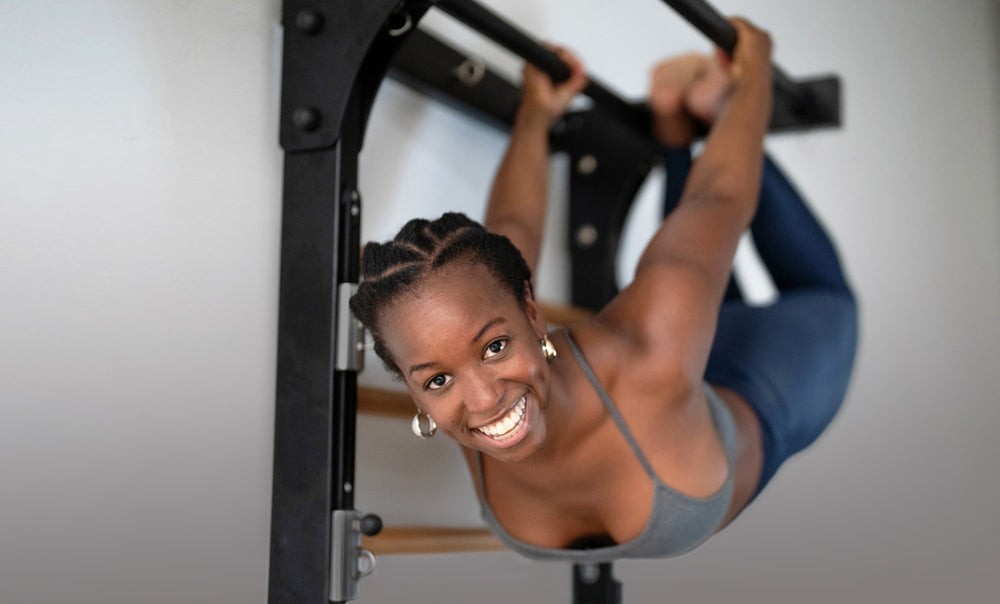 A woman has fun doing handing exercising on the Fuse Ladder