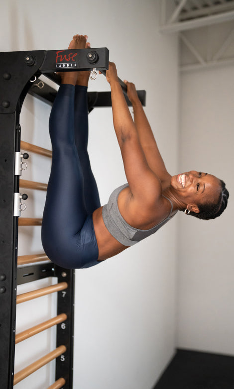 Yoga expert and dance instructor Ajia demonstrates a Fuse Ladder stretching ladder exercise cannot be done on a pilates springboard.