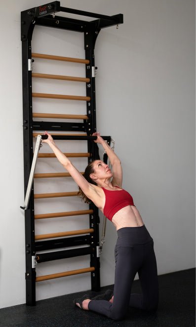 Pilates Anytime teacher Mariska Breland demonstrates Pilates backbend using the Fuse Ladder Pilates Cadillac push through bar.