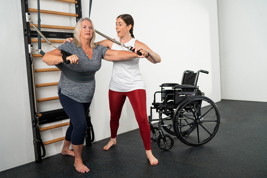 Neurorehabilitation expert and Kane School grad Meghann Koppele Duffy teaches wheelchair exercises and rehabilitation exercises to a client.