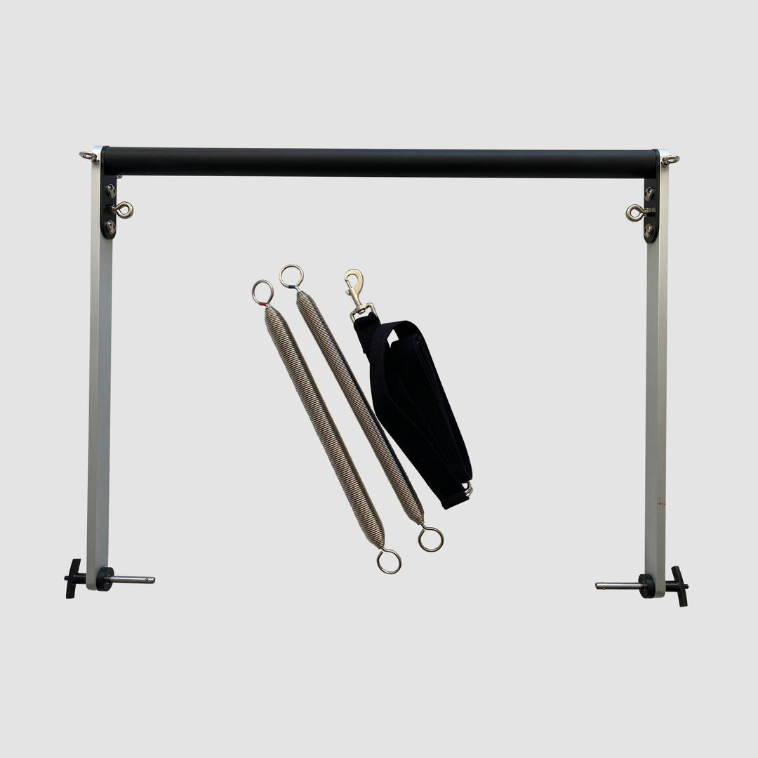 Pilates tower or Pilates Cadillac push-through bar with spring and strap attachments for use on the Fuse Ladder.